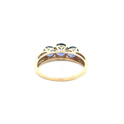 10K yellow gold ring with a trio of tanzanites and small diamonds