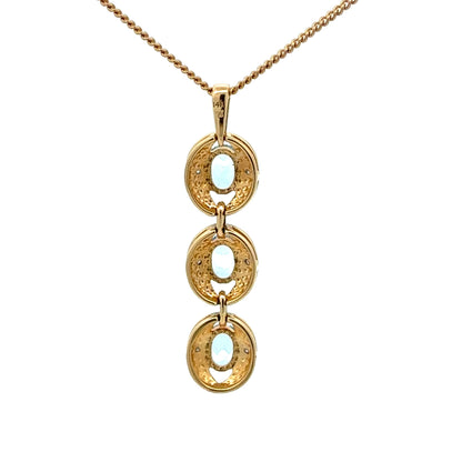 14k gold pendant with three aquamarine stones