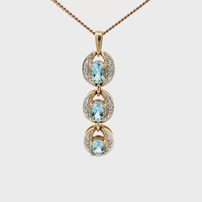 14k gold pendant with three aquamarine stones
